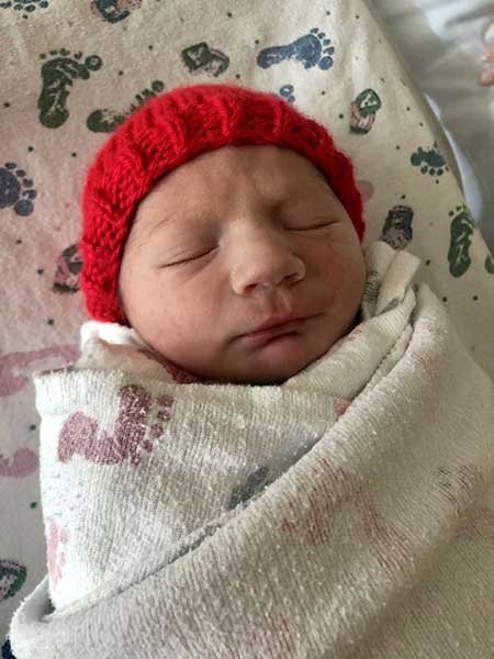 Jackson-Wiegele Newborn baby with a red hat