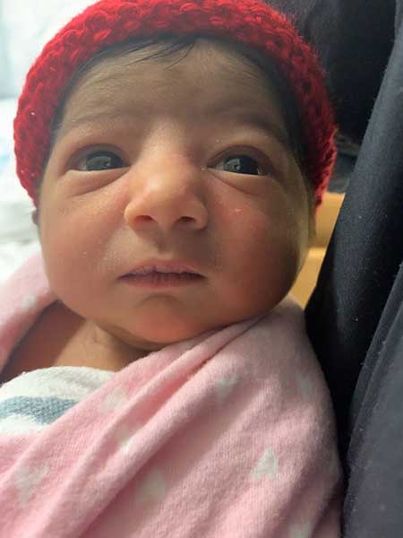 Krishaa-Gopinath Newborn Baby with a red hat